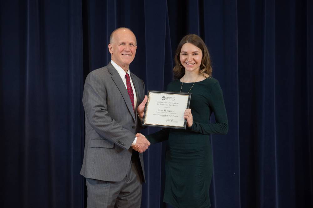 Dean Potteiger posing with a graduate student and their award